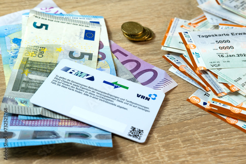 electronic eTicket on table among euro, monthly travel passes in germany for public transport, travel concept for country, accessibility diverse transportation options, Frankfurt - December 3, 2023 photo