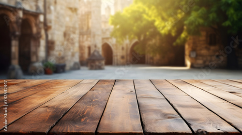 Wooden table foreground with a soft-focus medieval castle background. Table mockup for product presentation