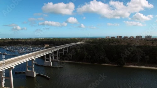 Wallpaper Mural Aerial Forward Shot Of Cars Moving On Seabreeze Bridge Amidst Trees In City Under Cloudy Sky - Daytona Beach , Florida Torontodigital.ca