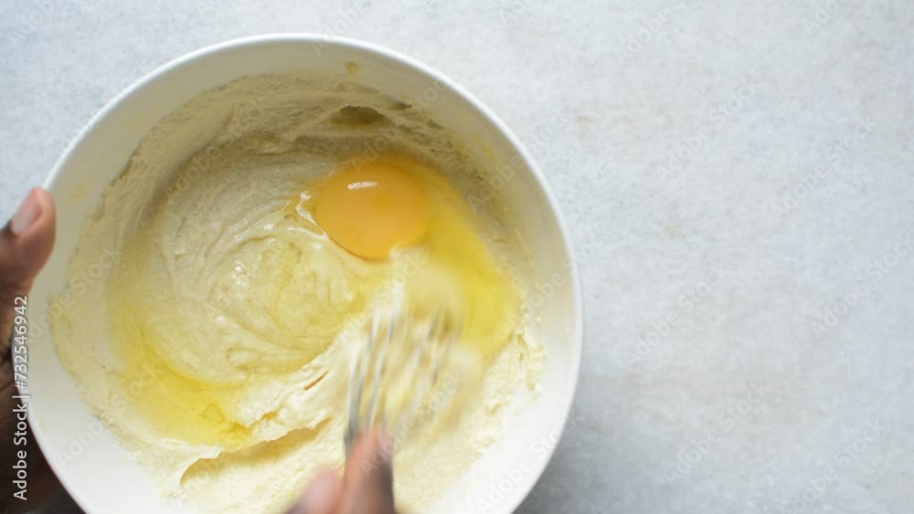 Creaming butter, sugar and egg with a whisk, the process of making a ...