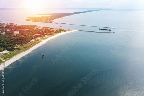 Ship goes through Strait of Baltiysk separating the Vistula Lagoon from Gdansk Bay. Aerial view photo