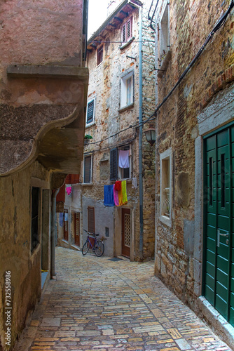 A quiet back street in the historic centre of the medieval coastal town of Rovinj in Istria, Croatia © dragoncello