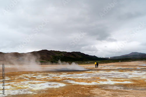 Hot springs in Hverir - Namafjall Geothermal Area in Iceland.Boiling mudpots in the geothermal area Hverir. Northeastern region, Krafla volcano, Iceland, Europe. Image of exotic world landmark. photo