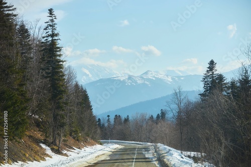 A mountain landscape and a road in the snow. Early spring or late autumn.