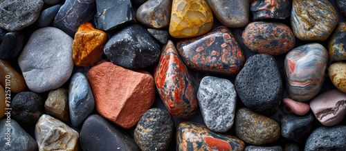 A collection of rocks in various colors and sizes, including Gas, Electric blue, Metal, Rock, Soil, Cuisine, Event, Pattern, and Carmine. photo