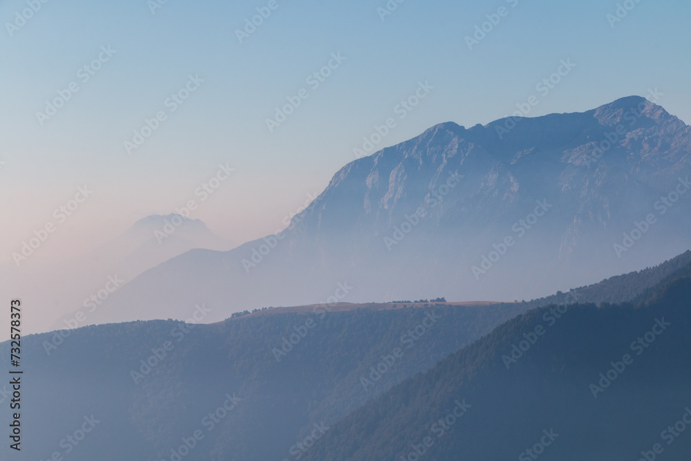 Spectacular mountain ranges silhouettes in morning.