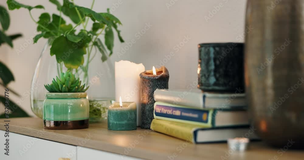 Table, closeup and books with candles, plants to relax for wellness, calm and zen for salon. Room, no people and stress relief for health, wealth and care for salon with balance and physical therapy Table, closeup and books with candles, plants to relax for wellness, calm and zen for salon. Room, no people and stress relief for health, wealth and care for salon with balance and physical therapy