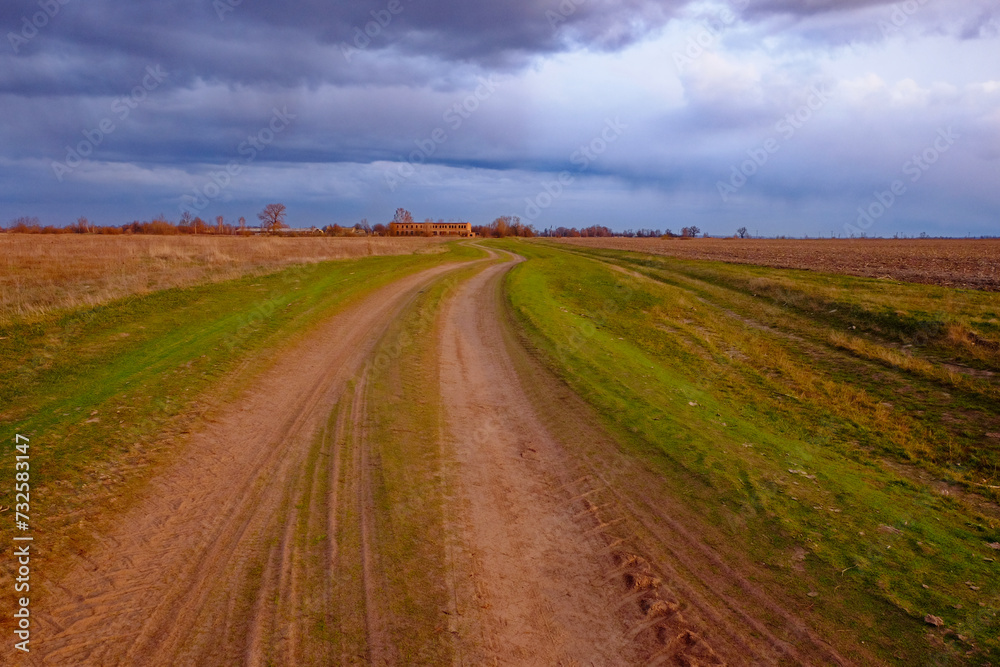A winding dirt path leads to a solitary house. A winding dirt path leads to a solitary house.