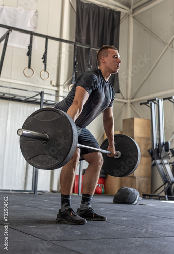 Man lifting barbell in the industrial gym