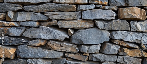 A close-up of a stone wall made of various rocks, a composite material, representing natural materials used in building fixtures like brickwork.