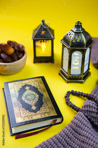 Holy Quran and dates fruit with islamic lantern decoration for ramadan