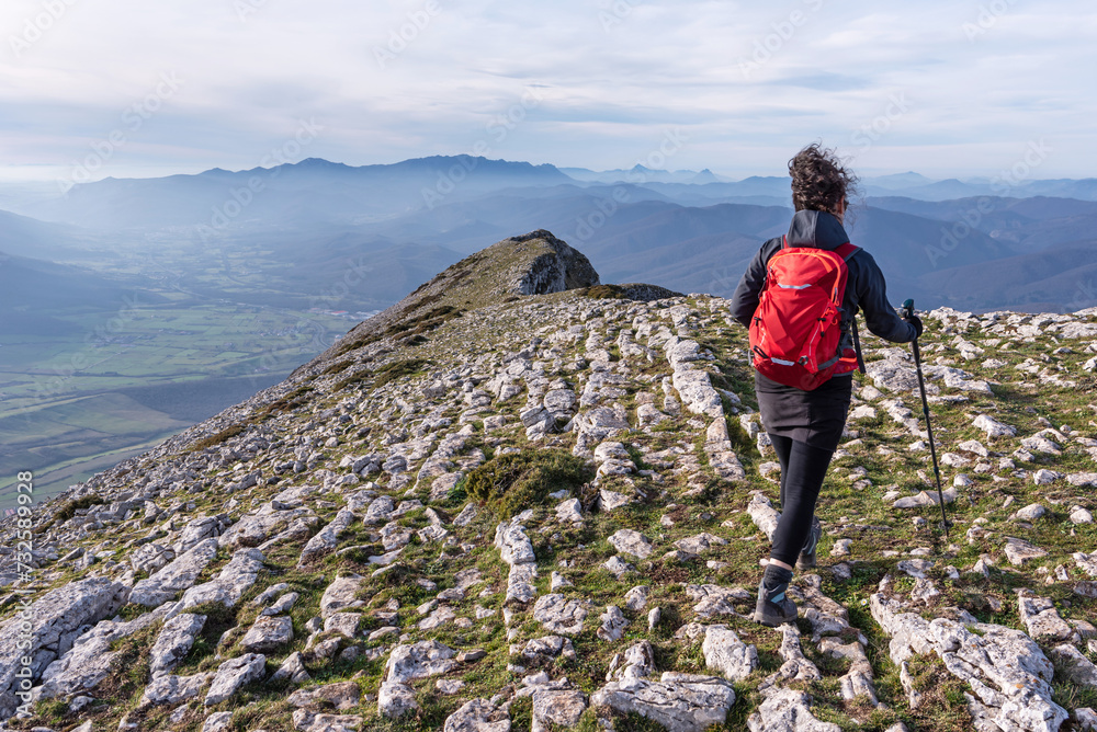 Obraz premium Hiker walking along a rocky ridge. Sierra de Andia, Navarra