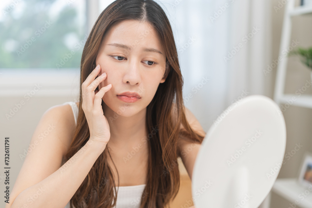 Dermatology, puberty asian young woman worry looking mirror, face allergic reaction from cosmetic, red or dark spot, rash. Beauty care skin problem treatment, blemish wrinkle, freckles from sunlight. Dermatology, puberty asian young woman worry looking mirror, face allergic reaction from cosmetic, red or dark spot, rash. Beauty care skin problem treatment, blemish wrinkle, freckles from sunlight.