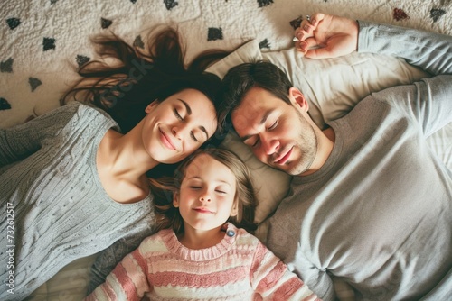 Happy family spending time together lying on floor carpet playing with kid son daughter family love care happiness joy smiling parents lifestyle relaxation home cute toddler mom young cheerful person