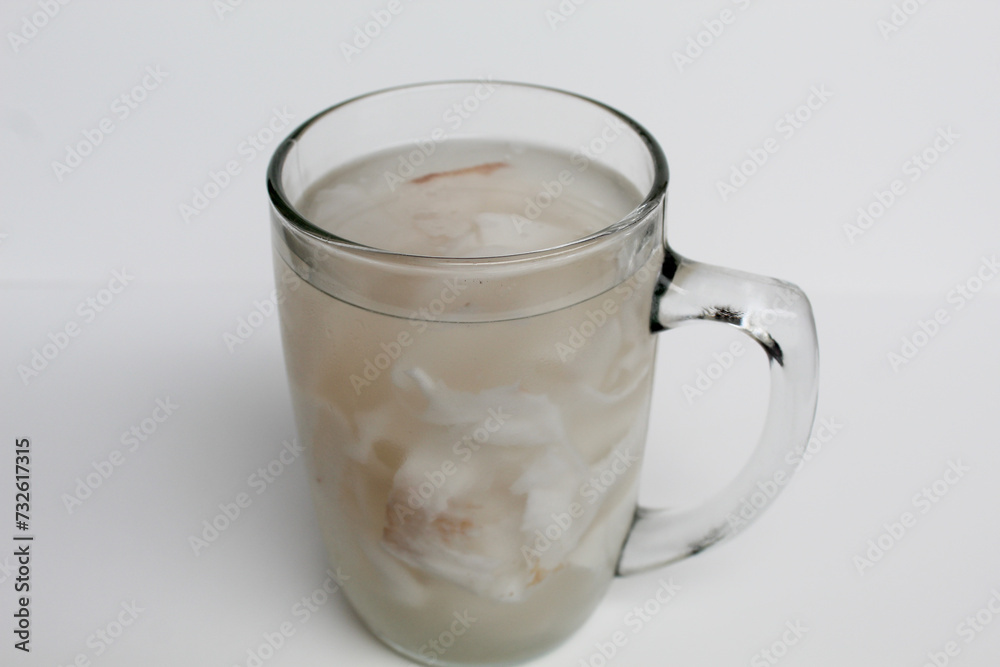 Beverage made from chilled or iced coconut water and young coconut flesh, isolated on white background Beverage made from chilled or iced coconut water and young coconut flesh, isolated on white background