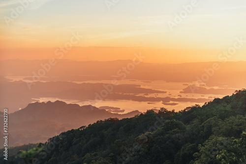 Capture the essence of adventure and tranquility in a striking landscape photo showcasing a camping setup amidst the majestic mountain ranges of Khao San Nok Wua and Pom Pee , Thailand. 
