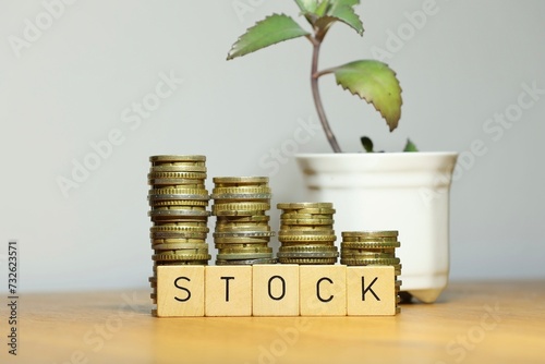 Successful stock trading and potential growth in stock market symbolized by stacked coins and plant