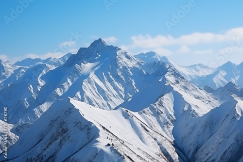 Majestic Snow-Covered Mountain Range Beneath a Blue Sky