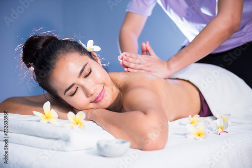 Thai oil back and spiral massage to Asian beauty woman in spa