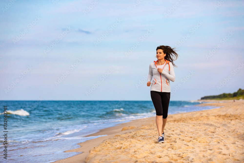 Young beautiful woman running on beach
Young beautiful woman running on beach