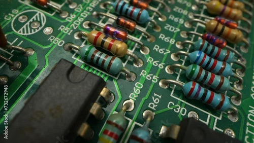 Macro Shot of Automatic Pick and Place machine quickly installs Components on Circuit Board. While board moving through Assembly Line. Electronics and Circuit board Manufacturing Factory.