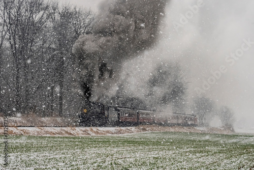 An Approaching Stem Passenger Train, in a Snow Storm, Blowing Black and White Smoke