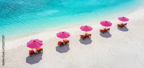 Fototapeta Naklejka Na Ścianę i Meble -  Aerial view of amazing beach with umbrellas and lounge chairs beds close to turquoise sea. Top view of summer beach landscape, idyllic inspire couple vacation, romantic holiday. Freedom travel tourism