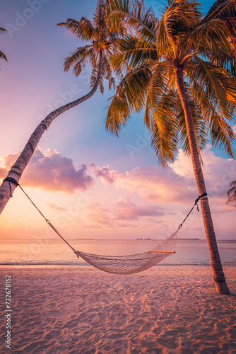 Fototapeta Naklejka Na Ścianę i Meble -  Beautiful silhouette of hammock on palm trees on tropical beach paradise at sunset. Carefree freedom tourism, summer nature, exotic shore coast. Tranquil travel landscape. Enjoy life, positive energy