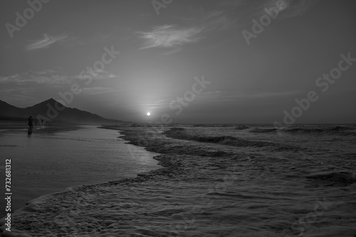 Sunset on Cofete beach in Fuerteventura in Jandia Natural Park with silhouettes and mountains photo