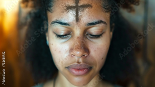 Humble woman with an ashen cross on her forehead in temple. Ash wednesday