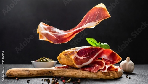 spanish ham jamon flying in ther on black background traditional meat specialty of the local cuisine