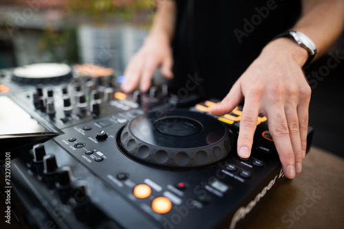 a DJ plays music on a controller at a party