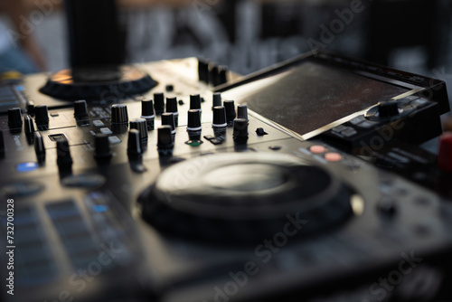 a DJ plays music on a controller at a party