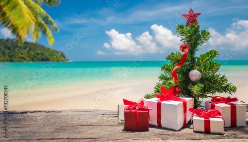 present boxes near green christmas tree on the tropical beach background