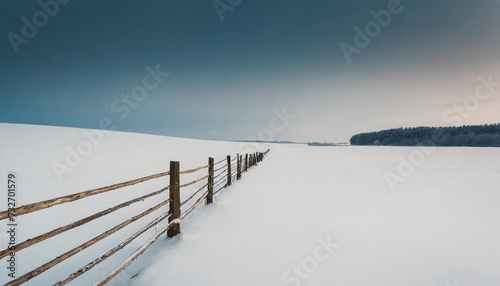 minimalistic landscape with a fence in a snowy field © Alexander