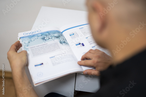 a beautician reads scientific literature in his office