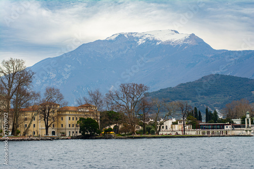 Waterfront view of the lake Garda at sunset with sailboats, Riva del Garda, Trentino Alto Adige region, Italy.