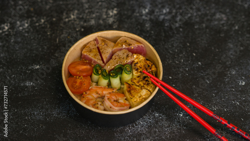 Seafood salad served on a beautiful plate. Salad with king prawns and prosciutto.