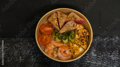 Seafood salad served on a beautiful plate. Salad with king prawns and prosciutto.