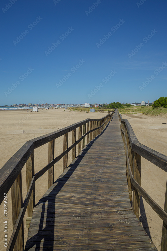 Wooden walkway extends along the beach of the port of Mar del Plata. Wooden walkway extends along the beach of the port of Mar del Plata.