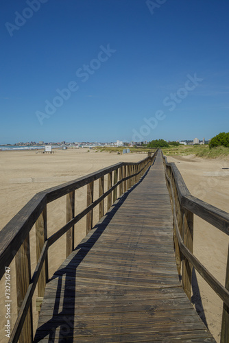 Wooden walkway extends along the beach of the port of Mar del Plata.