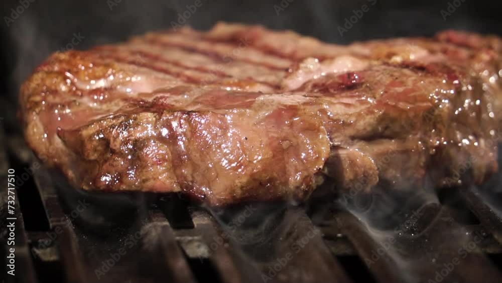 Close up of delicious beef steak on flaming grill. Barbecue grill. Cooking Health low cholesterol Lean Meat. Close up of delicious beef steak on flaming grill. Barbecue grill. Cooking Health low cholesterol Lean Meat.
