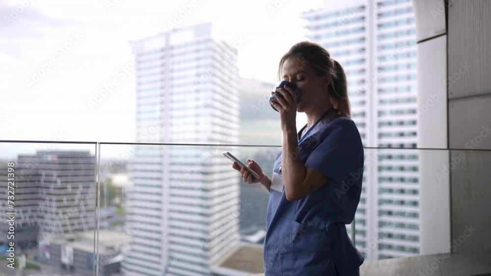 Female nurse smoking cigarette at balcony after work. Doctor feeling overwhelmed at work, taking break. Female nurse smoking cigarette at balcony after work. Doctor feeling overwhelmed at work, taking break.