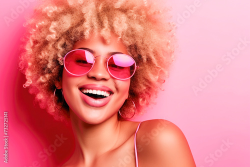 Joyful young girl with stylish afro and sunglasses, holidays concept, summertime concept