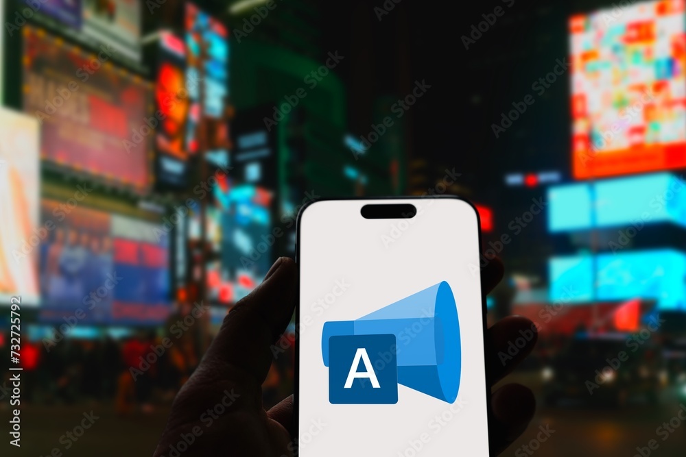 Microsoft Advertising Logo shown on a modern smartphone, behind it the