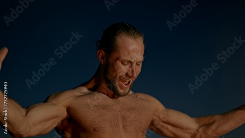 Billede på lærred Shirtless barbarian enjoying power near fire