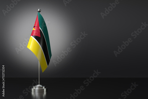 Small National Flag of the Republic of Mozambique on a Black Background. 3d Rendering