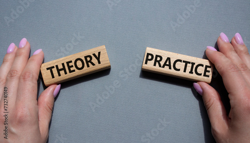 Theory or Practice symbol. Concept word Theory or Practice on wooden blocks. Businessman hand. Beautiful grey background. Business and Theory or Practice concept. Copy space photo