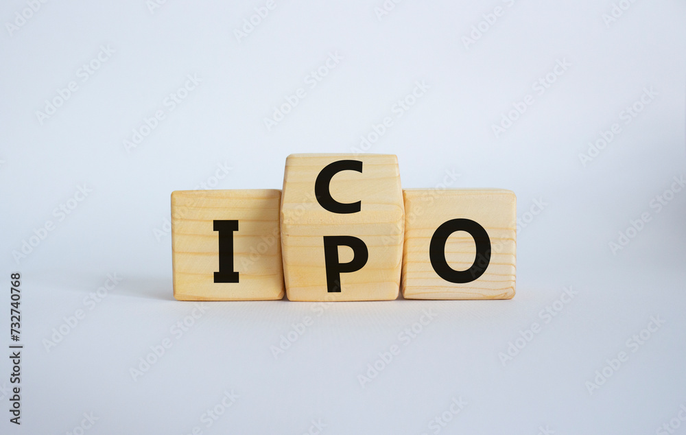 ICO and IPO symbol. Wooden cubes with words ICO - initial coin offering and IPO - initial public offering. Beautiful white background. Business concept. Copy space ICO and IPO symbol. Wooden cubes with words ICO - initial coin offering and IPO - initial public offering. Beautiful white background. Business concept. Copy space