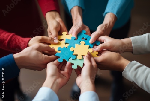 Close-up of a group solving a puzzle together, symbolic of teamwork photo